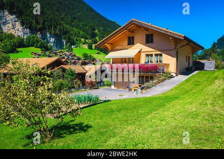 Cute wooden house with flowery terrace and small vegetable garden, Switzerland, Europe Stock Photo