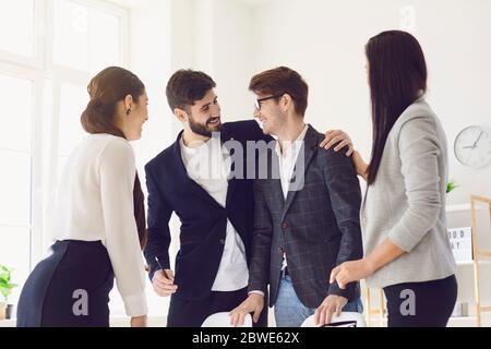 Happy friendly colleagues working communicating in office Stock Photo