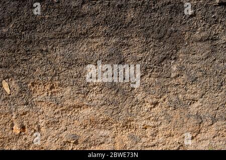 Brown color rough aged wall background. Exterior facade of an old abandoned house. Weathered and faded wall texture, Stock Photo