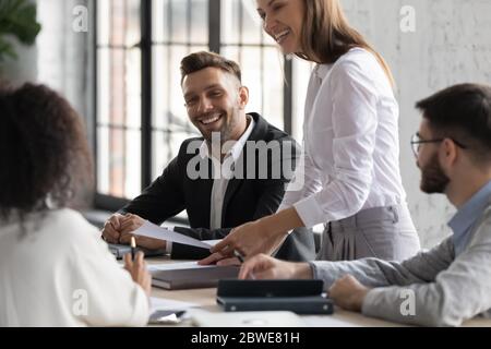 Happy diverse colleagues having fun at corporate meeting Stock Photo