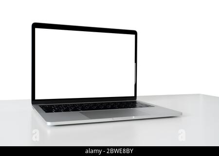 Workplace with laptop isolated on white. Blank screen, you can add your content here. Stock Photo