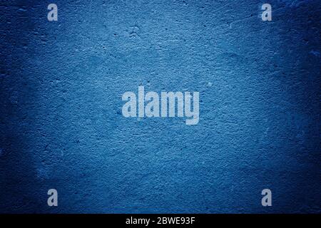 Texture of concrete and plaster on the wall. Blue Creative Tinting. Drips on the wall close-up. Wavy lines in the plaster. Trend color classic blue. C Stock Photo