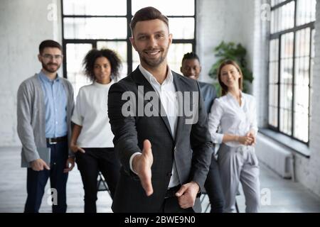 Head shot portrait confident smiling businessman offering hand for handshake Stock Photo