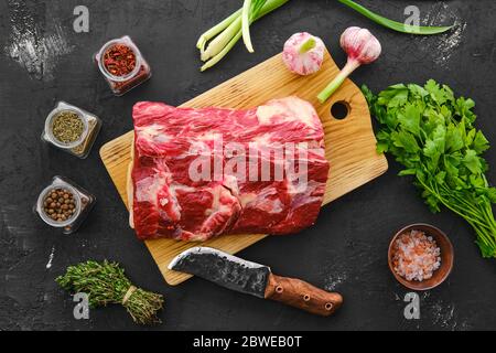 Raw beaf steaks with spices on black cutting board. Stock Photo by  ©Valentyn_Volkov 81018322