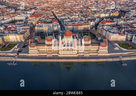 Budapest, Hungary - Aerial view of the Hungarian Parliament Building in warm colors at sunset. No traffic on the streets Stock Photo