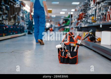 Toolbox in tool store, worker on background Stock Photo