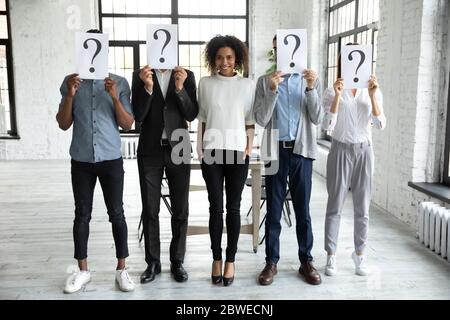 Smiling African American businesswoman standing with unknown people Stock Photo