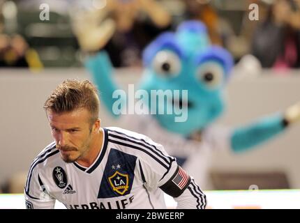 David Beckham is cheered on by LA Galaxy mascot 'Cosmos' during the MLS game with San Jose Earthquakes at the Home Depot Center, Carson, California. 23 May 2012 Stock Photo