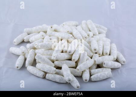 A lot of cotton threads in bobbins scattered on the table. Materials for sewing and needlework. Stock Photo