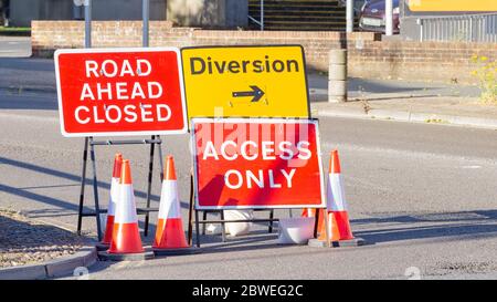 Red and Yellow Road Signs Indicating a Road Closure and Diversion Stock Photo