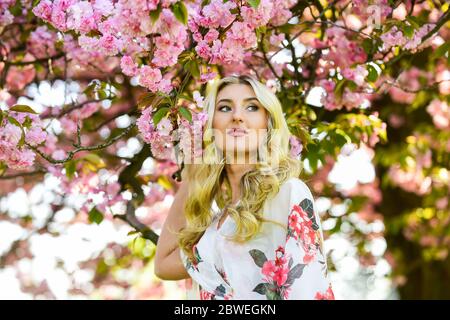 Floral aroma. Harmony and female energy. Spring blossoming tree. Spring symbol. Reasons why flowers always make women happy. Happy spring day. Girl enjoy sakura in garden. Cherry tree. Good vibes. Stock Photo