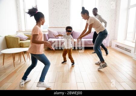 In living room African family play hide-and-seek game Stock Photo