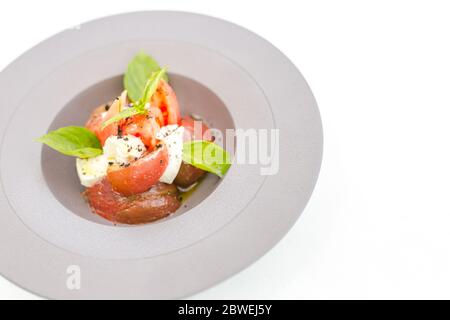 Insalata caprese. Italian gourmet salad, made of tomatoes, zucchini and buffalo mozzarella cheese Stock Photo