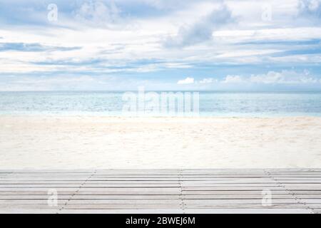 Wooden floor over white sandy beach landscape, cloudy sky. Tranquil tropical pattern Stock Photo