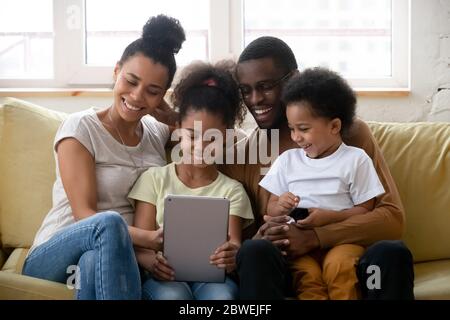 African family with kids spend free time using tablet device Stock Photo