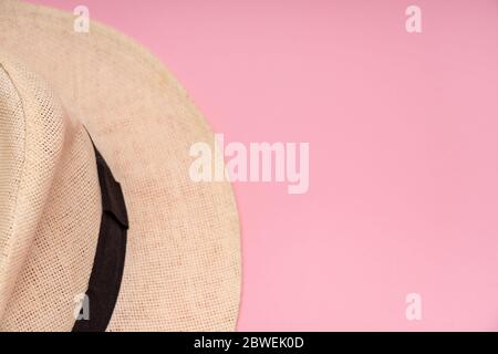 Half a straw hat on a pink background. Conceptual photo. Close-up. Copy space. Stock Photo