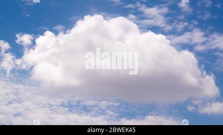 Big single nature white cumulus cloud on clear blue sky background Stock Photo
