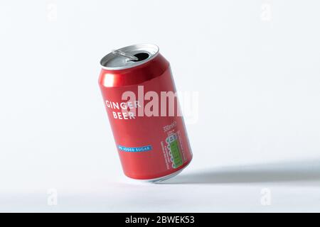 An opened can of ginger beer on a white isolated background. Drink and recycling concept. Stock Photo