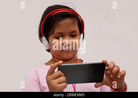 Girl Listening Music While Using Smart Phone Stock Photo