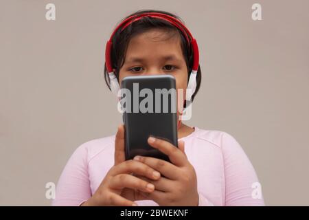 Girl Listening Music While Using Smart Phone Stock Photo