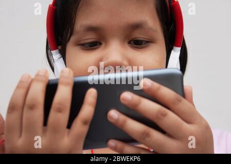 Girl Listening Music While Using Smart Phone Stock Photo