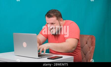 Funny frames of male using laptop. man working on a computer pretending to be a hacker. Stock Photo