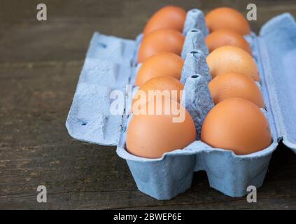 A box of chicken eggs on wooden background Stock Photo