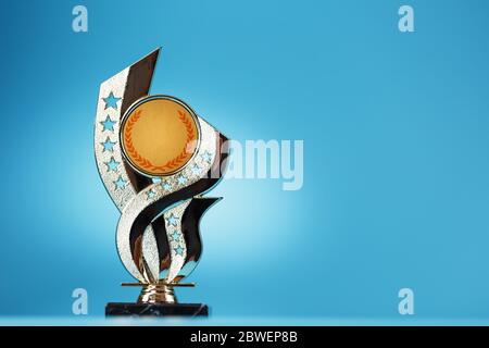 Gold Prize on a blue background on a blue background. Isolate free space for text. Stock Photo