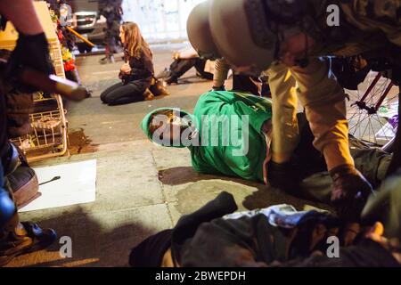 Beijing, USA. 30th May, 2020. Riot police officers arrest a small group of protestors at a memorial to George Floyd in Minneapolis, the United States, on May 30, 2020. TO GO WITH XINHUA HEADLINES OF JUNE 1, 2020 Credit: Angus Alexander/Xinhua/Alamy Live News Stock Photo