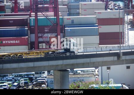 Hong Kong, China - Nov 28, 2016: Empty trailer truck on elevated road with container yard in hongkong port as background Stock Photo