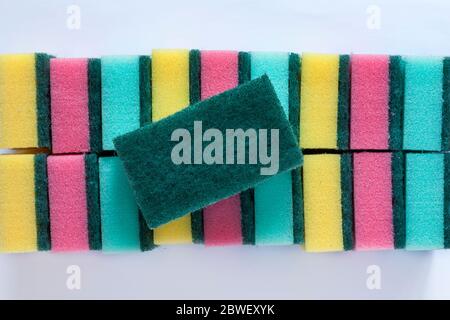 looking down on colourful sponge scourers removed from packaging set on white background - from above Stock Photo