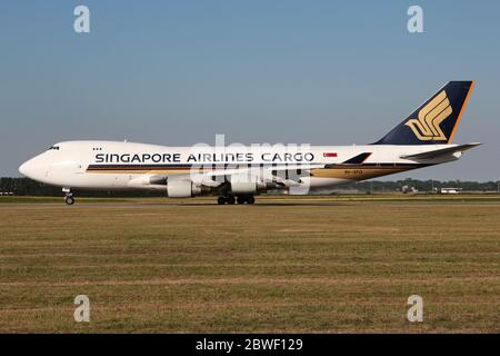 Singapore Airlines Cargo Boeing 747-400F with registration 9V-SFD rolling on taxiway V of Amsterdam Airport Schiphol. Stock Photo