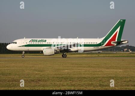Italian Alitalia Airbus A320-200 with registration EI-DTB rolling on taxiway V of Amsterdam Airport Schiphol. Stock Photo