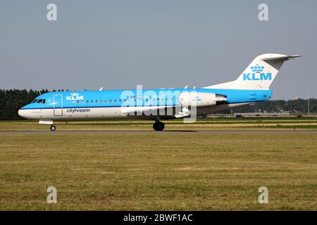 Dutch KLM Cityhopper Fokker 70 with registration PH-KZV rolling on taxiway V of Amsterdam Airport Schiphol. Stock Photo