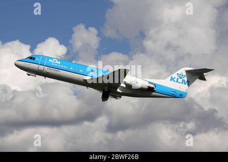 Dutch KLM Cityhopper Fokker 70 with registration PH-WXD just airborne at Amsterdam Airport Schiphol. Stock Photo