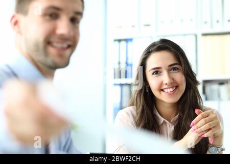 Joyful young colleagues working together at their project Stock Photo