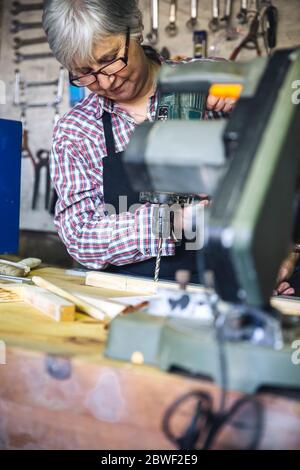 Senior woman in a carpentry Stock Photo
