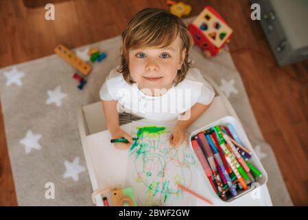 Little blond boy plays painting at home. entertainment during quarantine. family at home coronavirus. Stock Photo