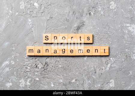 sports management word written on wood block. sports management text on cement table for your desing, concept. Stock Photo