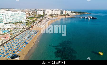 Aerial bird's eye view of Sunrise beach at Fig tree in Protaras, Paralimni, Famagusta, Cyprus. The famous tourist attraction family bay with golden sa Stock Photo