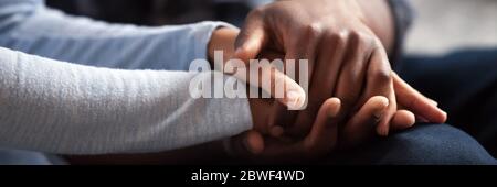 African couple holding hands, close up view horizontal image Stock Photo