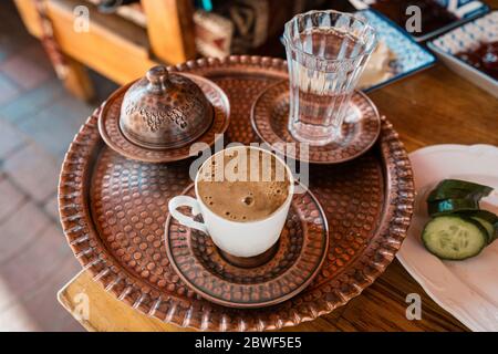 https://l450v.alamy.com/450v/2bwf5e5/turkish-traditional-coffee-with-cup-and-glass-of-water-on-copper-tray-2bwf5e5.jpg