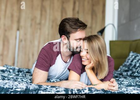 Caucasian couple lying on bed together