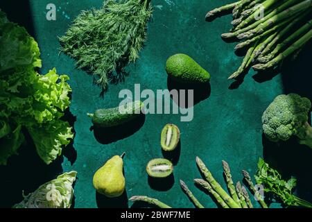 Fresh green fruits and vegetables on green background. Stock Photo