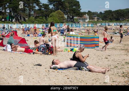 Crowds enjoy the hot weather at Avon beach, Mudeford as the coronavirus lockdown measures are relaxed to enable people to travel to the south coast. Stock Photo