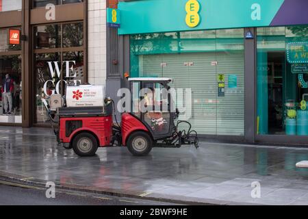 Pedestrian streets and pavements are cleaned ahead of the opening of retail shops in the West End of London after coronavirus, England, United Kingdom Stock Photo