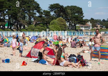 Crowds enjoy the hot weather at Avon beach, Mudeford as the coronavirus lockdown measures are relaxed to enable people to travel to the south coast. Stock Photo