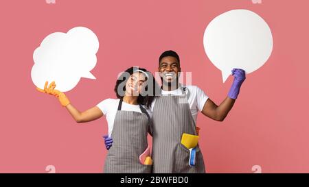 Empty Speech Bubbles In Hands Of Black Man And Woman Professional Cleaners Stock Photo