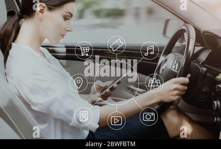 Woman Using Voice Search On Phone Driving Sitting In Car Stock Photo