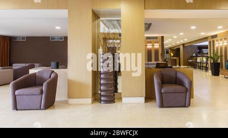 Armchairs and decor in lobby of modern hotel Stock Photo